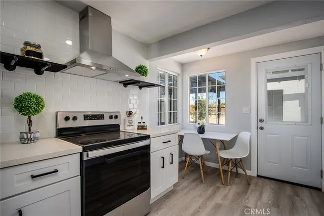 a kitchen with stainless steel appliances granite countertop a stove and a refrigerator