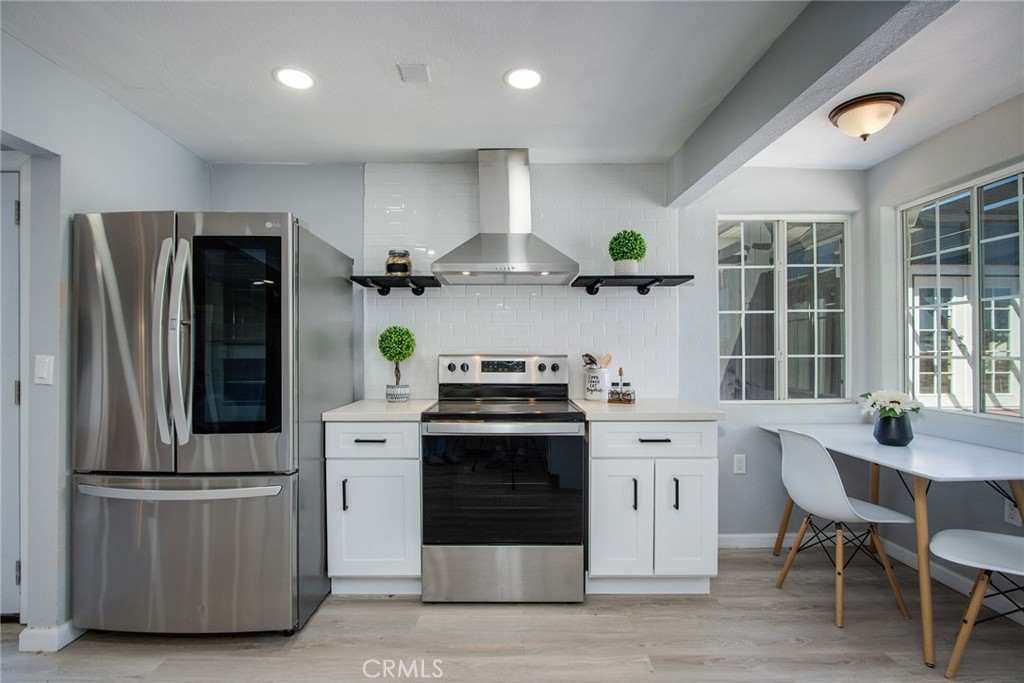 62932 Shifting Sands Joshua Tree, CA 92252 - Photo 12 of 45 a kitchen with stainless steel appliances granite countertop a stove and a refrigerator