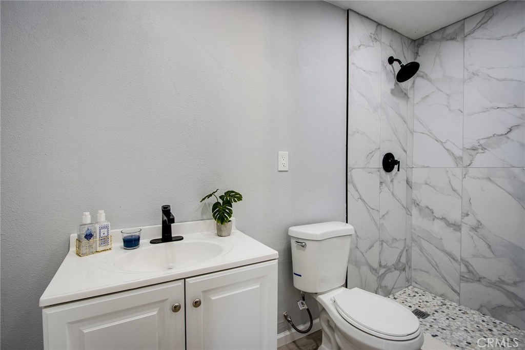 62932 Shifting Sands Joshua Tree, CA 92252 - Photo 15 of 45 a bathroom with a sink a toilet and shower