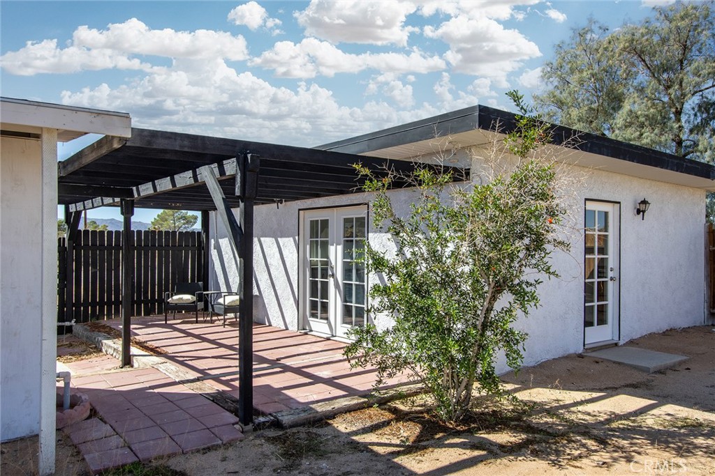 62932 Shifting Sands Joshua Tree, CA 92252 - Photo 25 of 45 a patio with table and chairs and potted plants