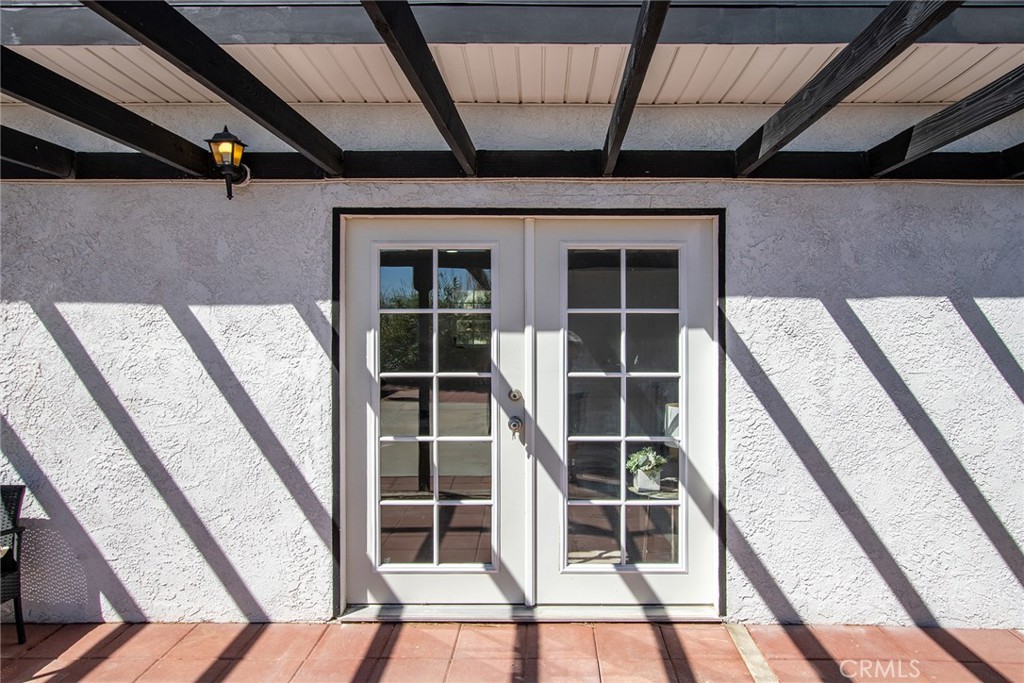62932 Shifting Sands Joshua Tree, CA 92252 - Photo 27 of 45 a view of an empty room with wooden floor and windows