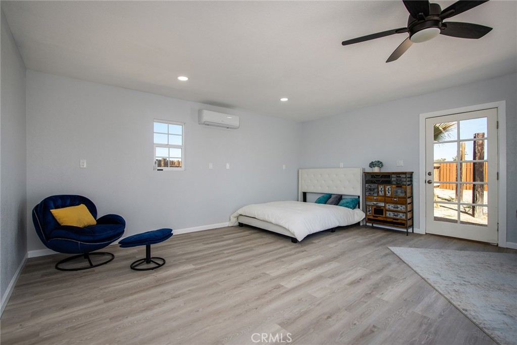 62932 Shifting Sands Joshua Tree, CA 92252 - Photo 28 of 45 a bedroom with furniture and a window