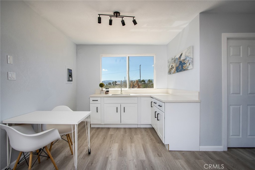 62932 Shifting Sands Joshua Tree, CA 92252 - Photo 32 of 45 a kitchen with a sink cabinets and dining table chair