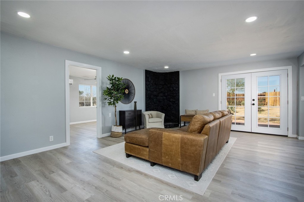 62932 Shifting Sands Joshua Tree, CA 92252 - Photo 8 of 45 a living room with furniture and a wooden floor