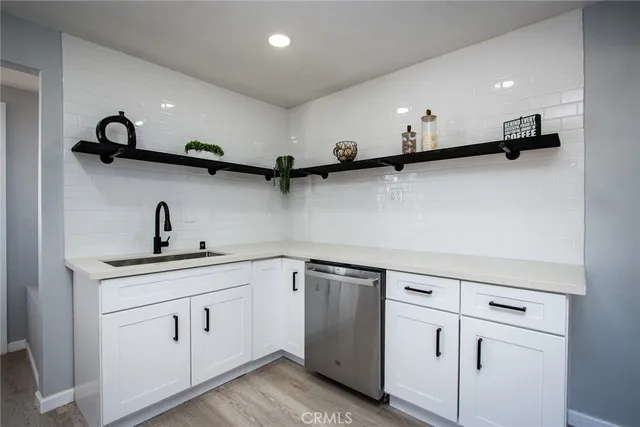 a kitchen with a sink stove and cabinets