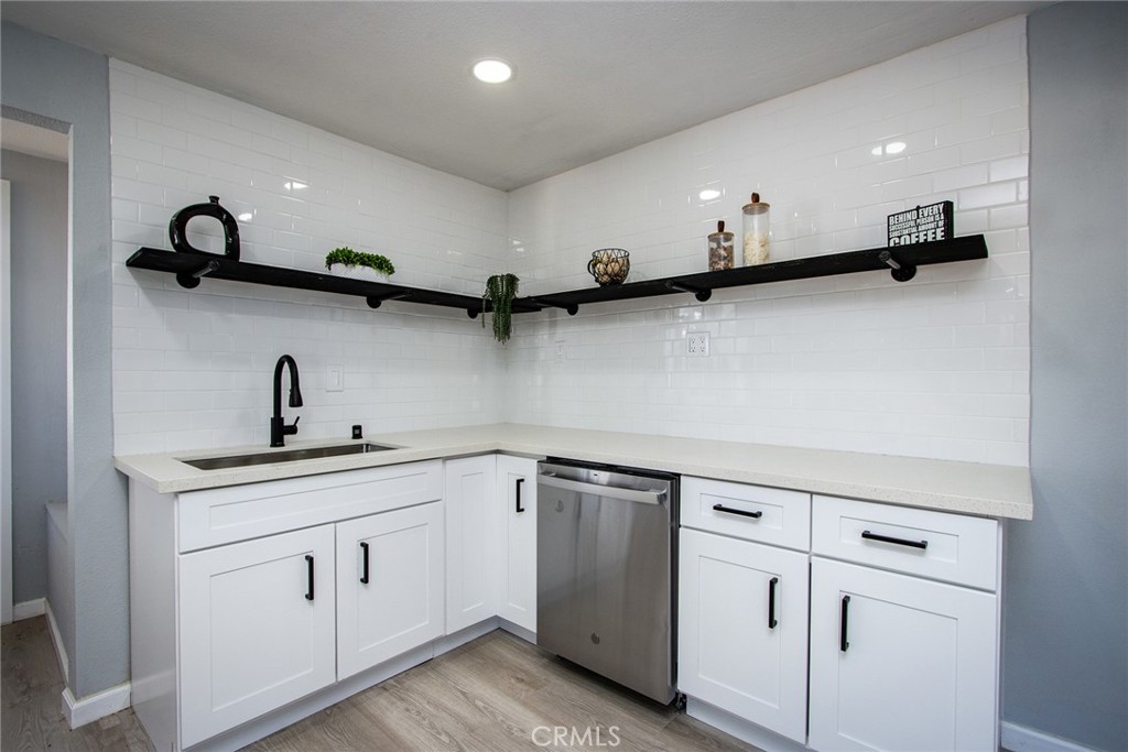 62932 Shifting Sands Joshua Tree, CA 92252 - Photo 10 of 45 a kitchen with white cabinets and sink