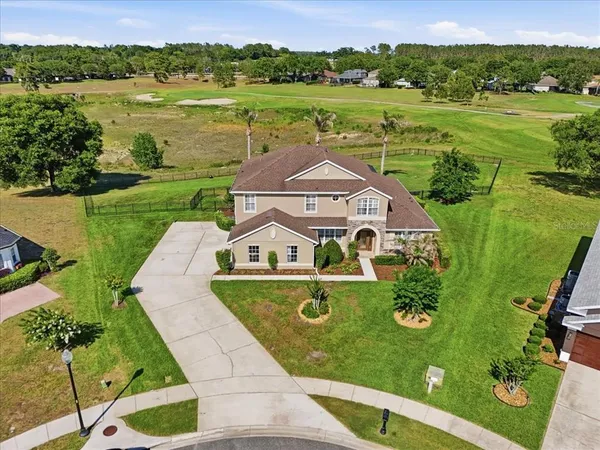 an aerial view of a house with big yard