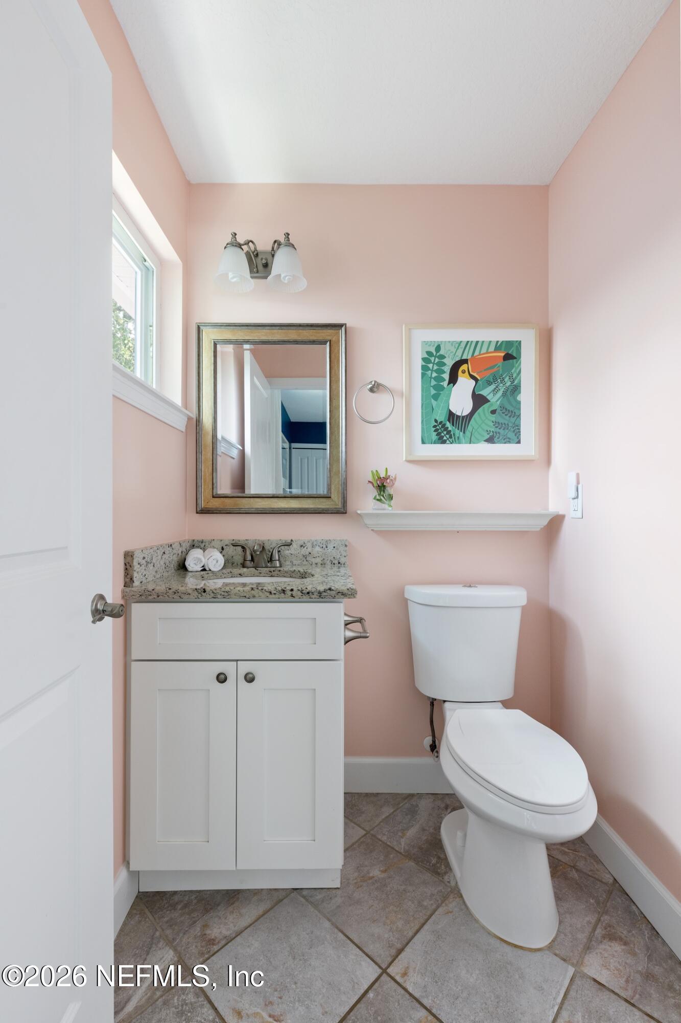 406 3rd St Street St. Augustine, FL 32084 - Photo 11 of 56 a white toilet sitting next to a bathroom sink