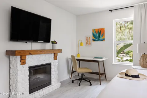 a bedroom with furniture and a wooden floor
