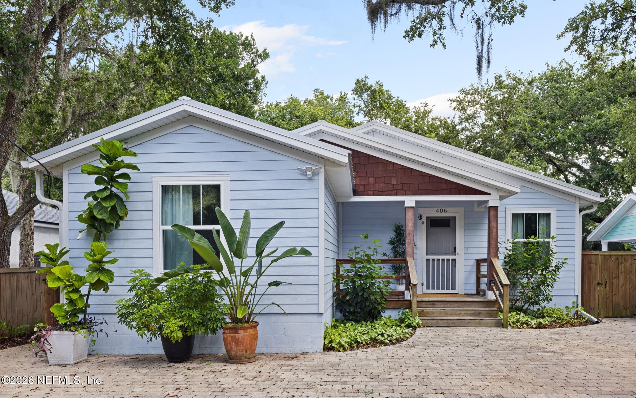 406 3rd St Street St. Augustine, FL 32084 - Photo 32 of 56 a front view of house with yard and trees around