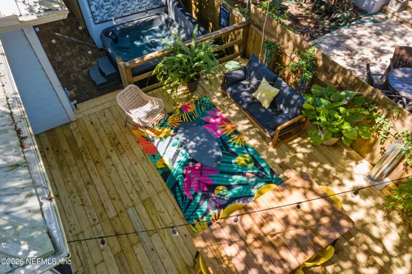 an aerial view of residential houses with outdoor space and trees