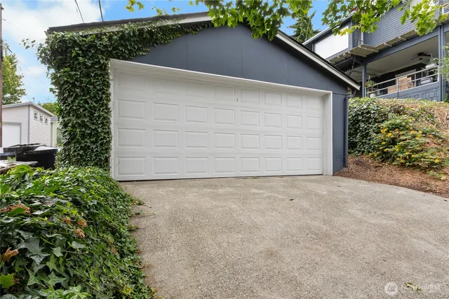 an aerial view of a house with a garden and a car parked