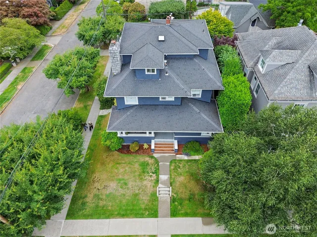 an aerial view of a house with yard and a patio