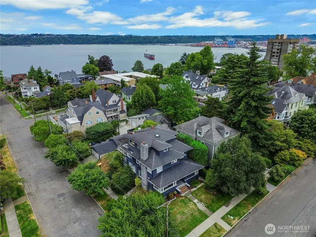 an aerial view of a house with a garden and lake view