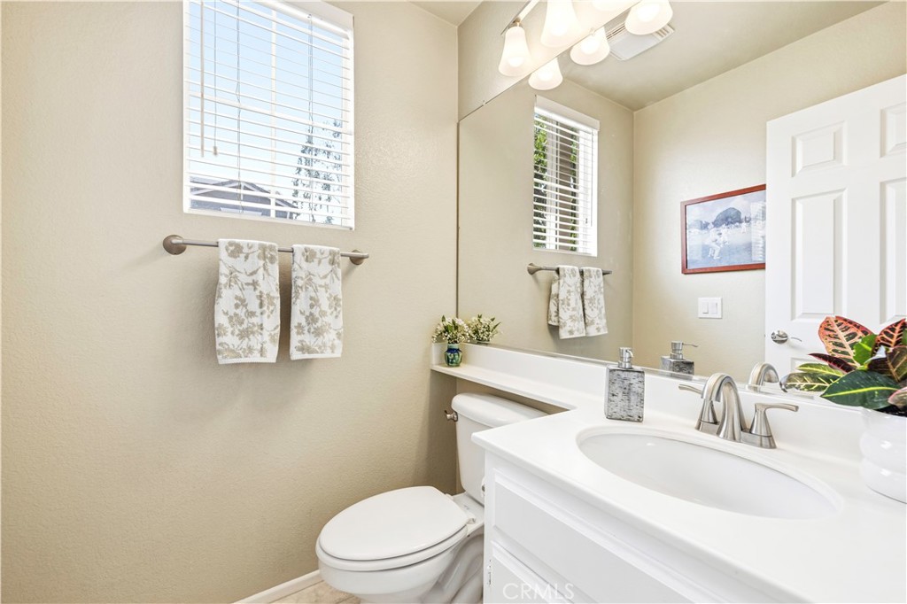 28033 Memory Lane Valencia, CA 91354 - Photo 4 of 40 a bathroom with a sink a mirror and a toilet