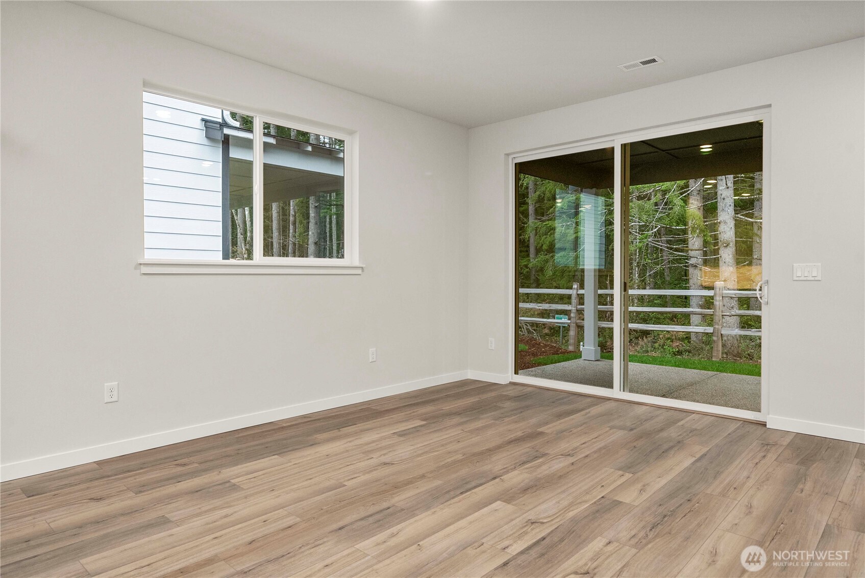 4083 Southwest Rustler Street Port Orchard, WA 98367 - Photo 13 of 32 a view of an empty room with wooden floor and a window