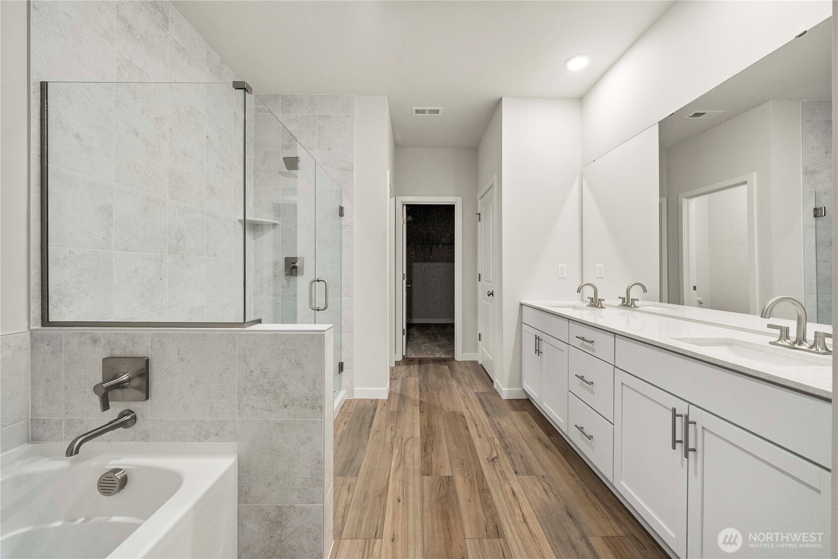 4083 Southwest Rustler Street Port Orchard, WA 98367 - Photo 16 of 32 a spacious bathroom with a double vanity sink a mirror and a bathtub