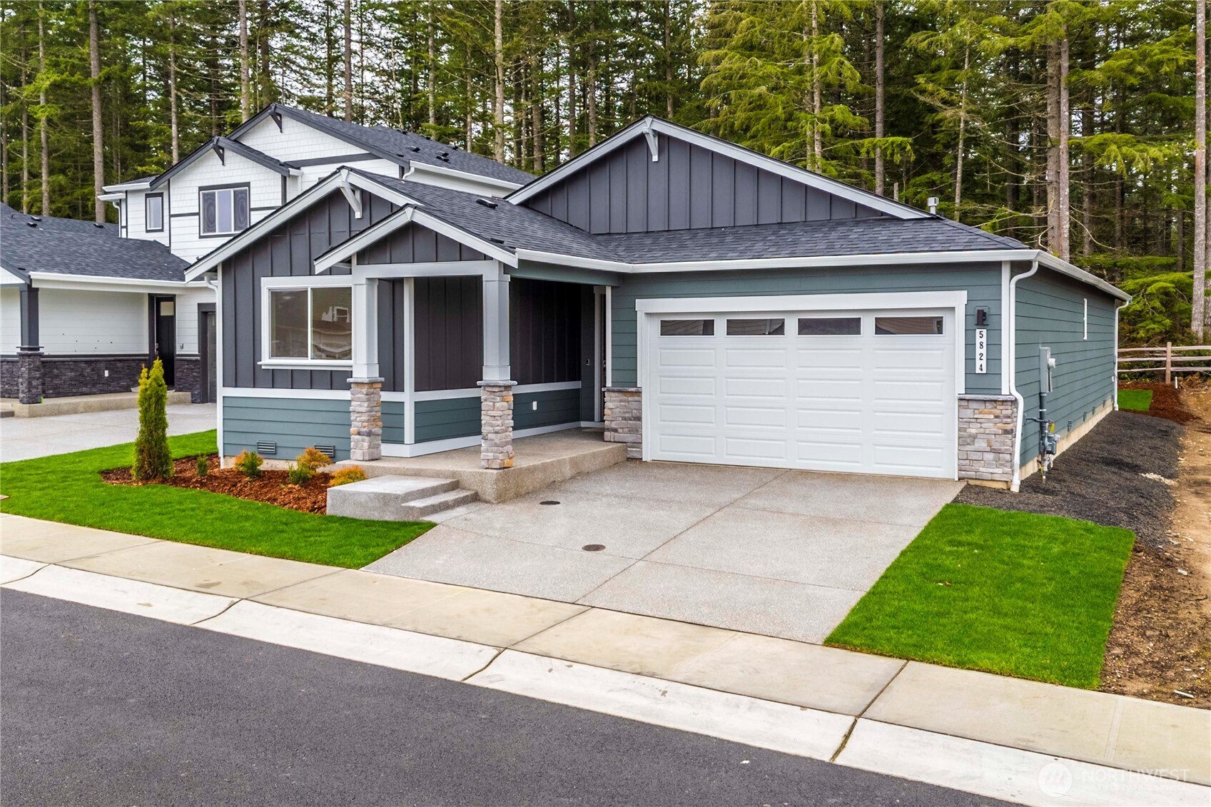 4083 Southwest Rustler Street Port Orchard, WA 98367 - Photo 29 of 32 a front view of a house with a yard and garage