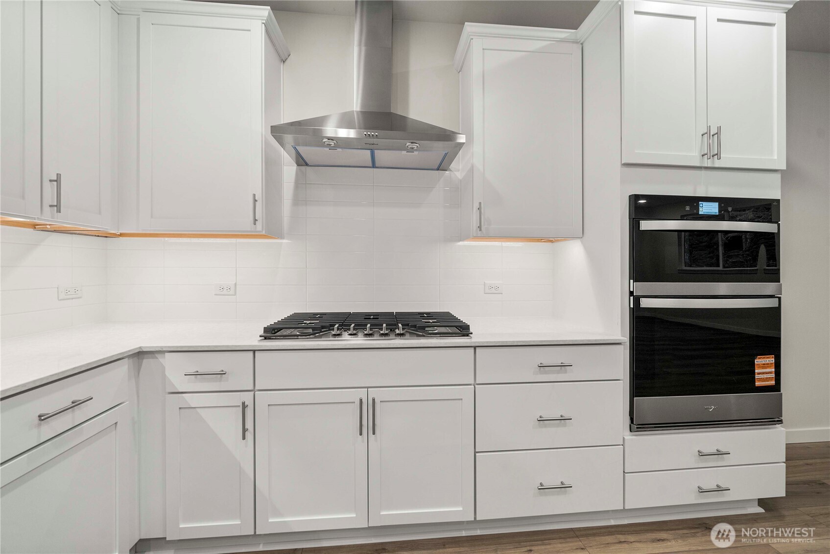 4083 Southwest Rustler Street Port Orchard, WA 98367 - Photo 6 of 32 a kitchen with white cabinets and white appliances