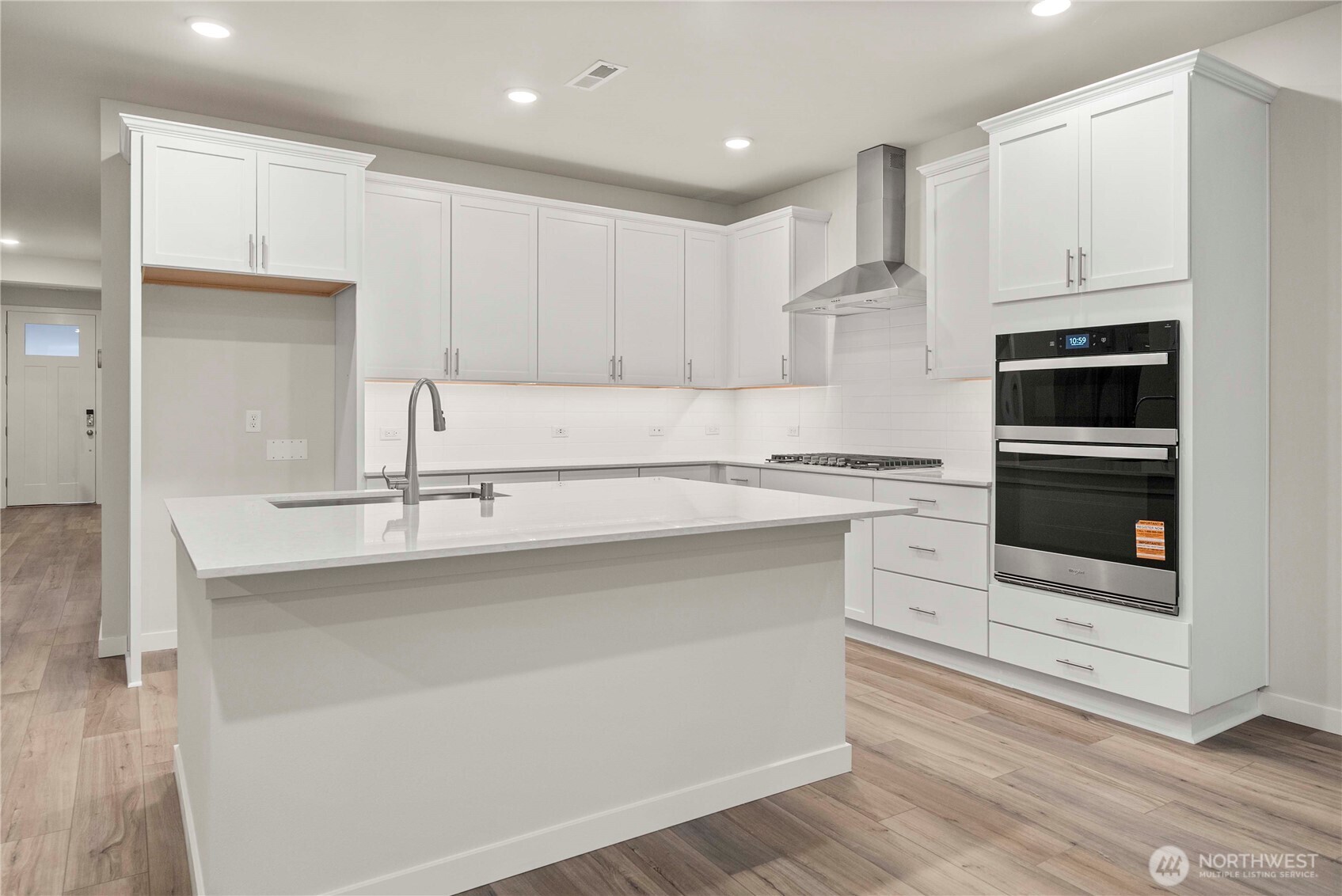 4083 Southwest Rustler Street Port Orchard, WA 98367 - Photo 7 of 32 a kitchen with stainless steel appliances granite countertop a sink and a stove top oven