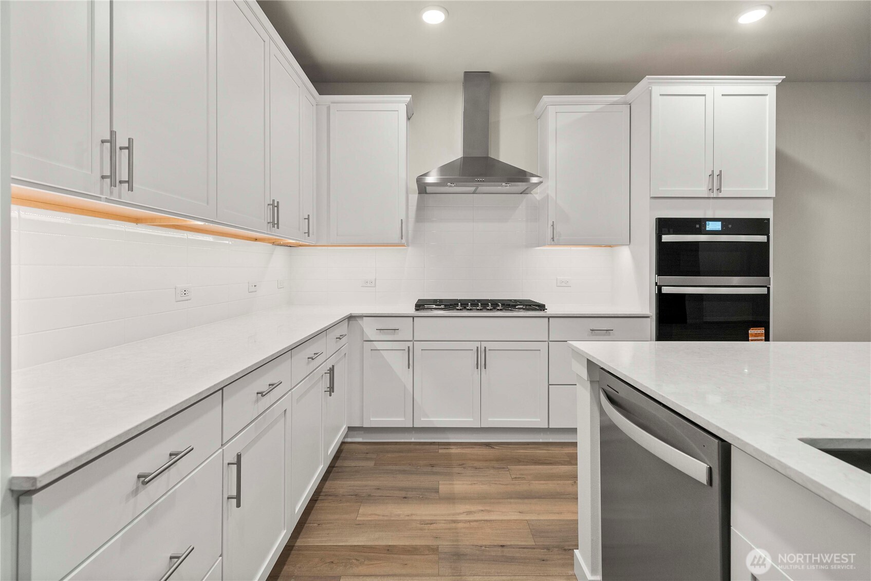 4083 Southwest Rustler Street Port Orchard, WA 98367 - Photo 9 of 32 a kitchen with granite countertop white cabinets and white appliances
