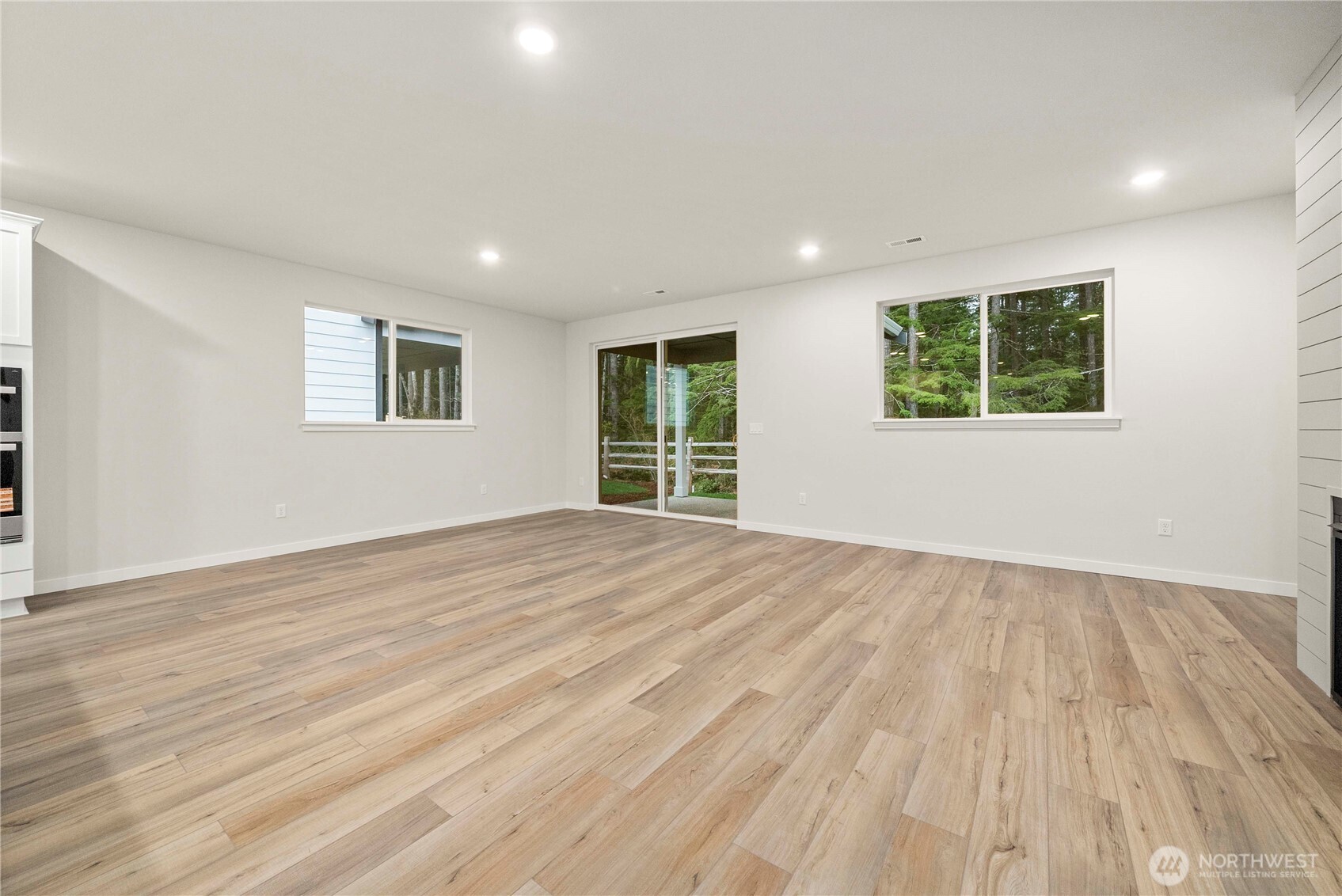 4083 Southwest Rustler Street Port Orchard, WA 98367 - Photo 10 of 32 a view of an empty room with wooden floor and a window