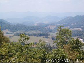 3 Glades Road Clyde, NC 28721 - Photo 4 of 12 a view of a lake with mountains in the background