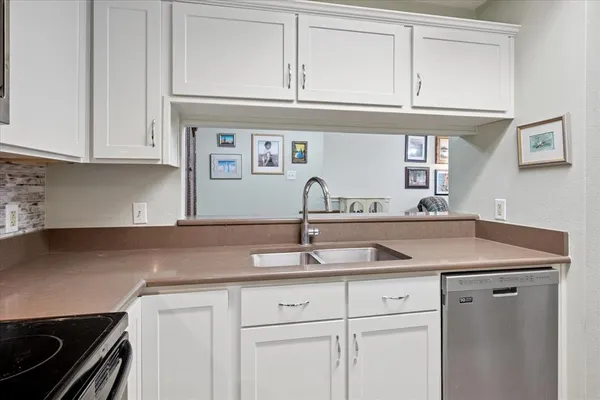 a kitchen with granite countertop a sink and cabinets