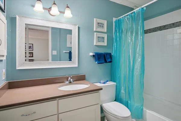 a bathroom with a sink toilet and mirror