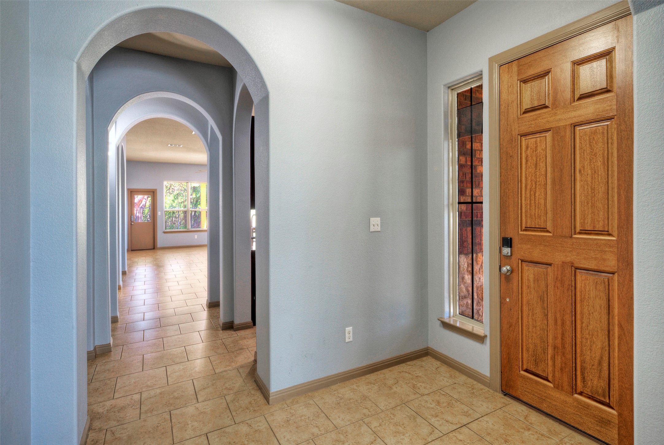 1601 Nelson Ranch Loop Cedar Park, TX 78613 - Photo 10 of 30 A welcoming entryway transitions into a series of graceful arched hallways over tile flooring.