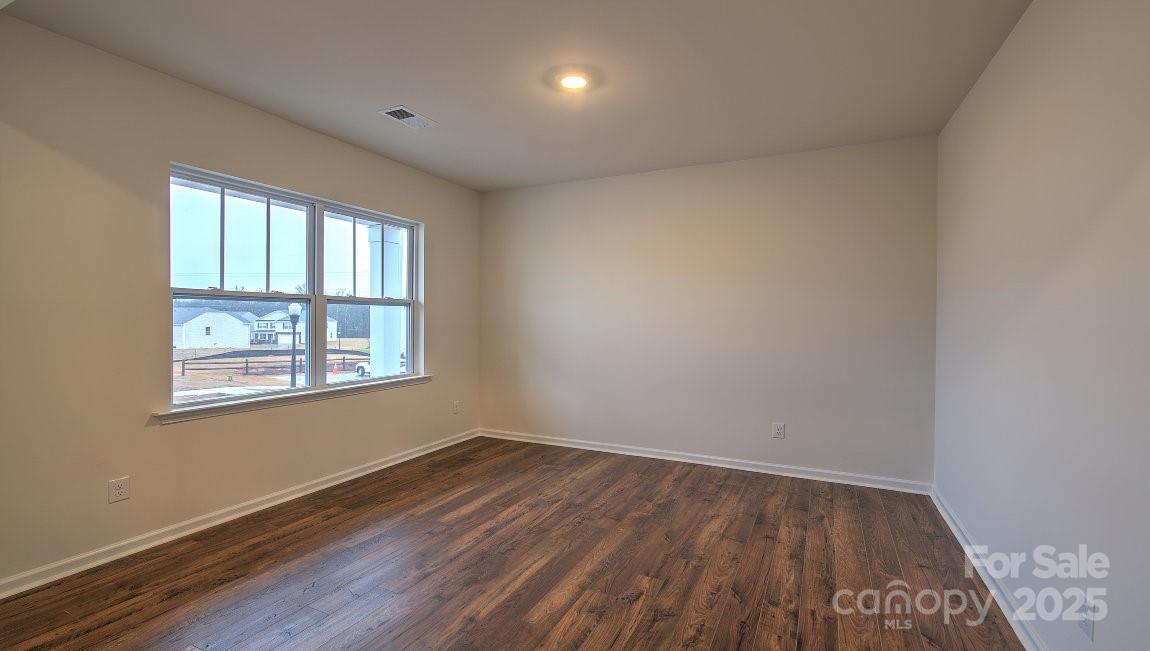 109 Salers Road Fletcher, NC 28732 - Photo 12 of 27 a view of an empty room with wooden floor and a window