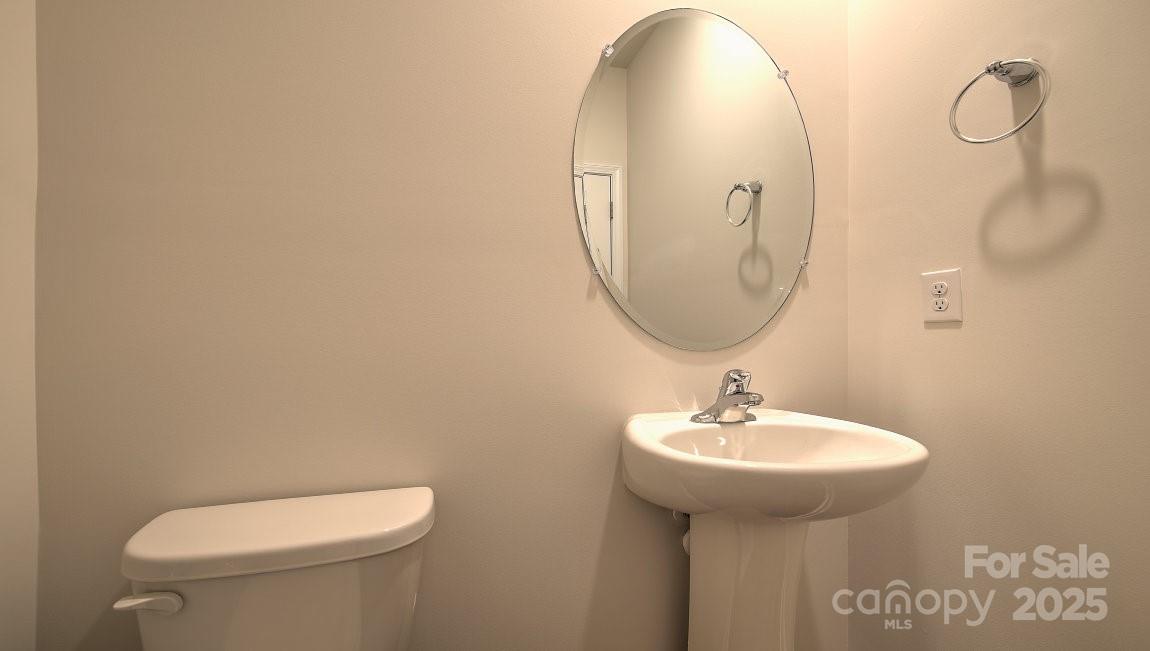 109 Salers Road Fletcher, NC 28732 - Photo 16 of 27 a bathroom with a toilet sink and mirror