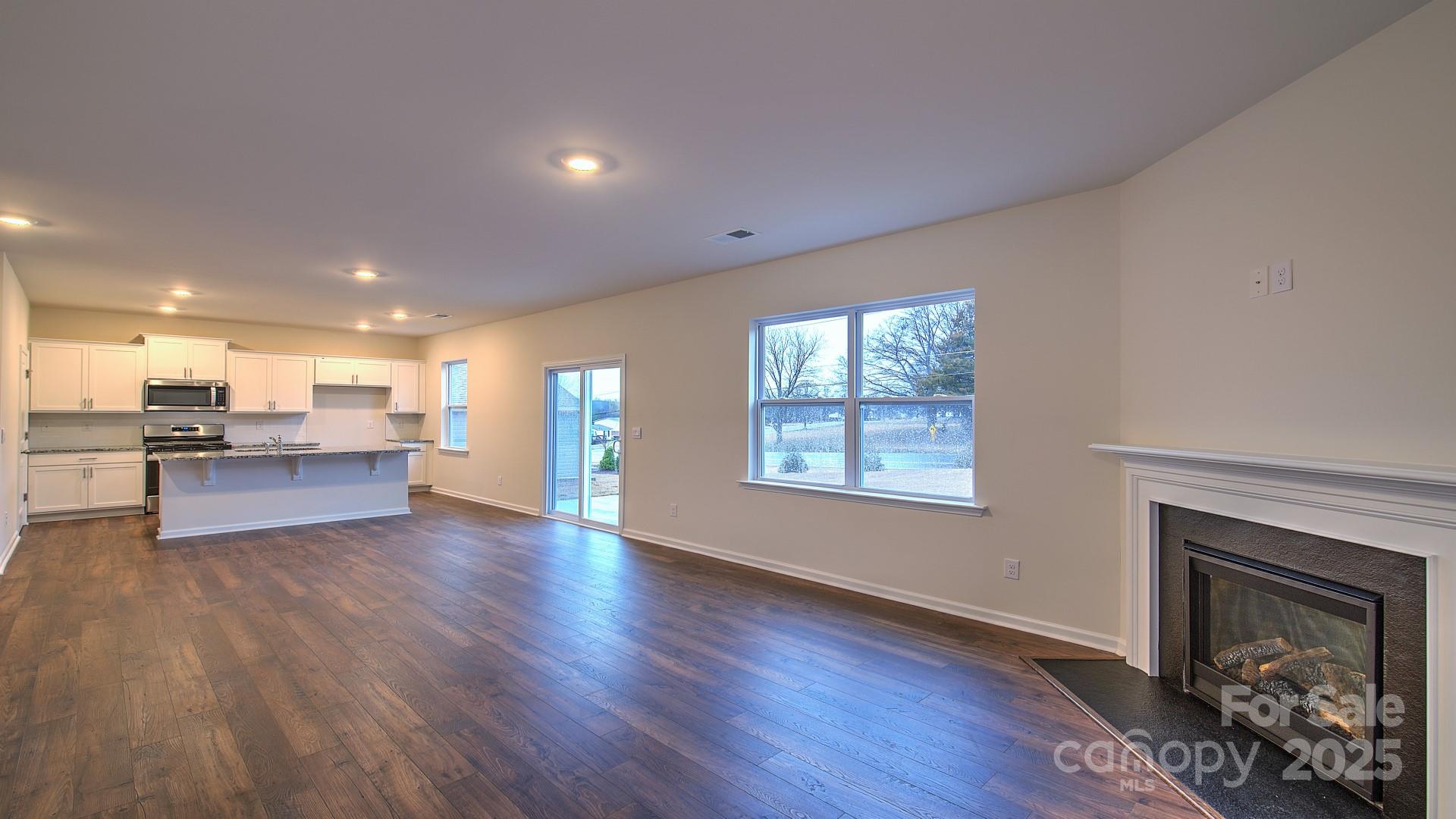 109 Salers Road Fletcher, NC 28732 - Photo 7 of 27 a view of kitchen with kitchen island wooden floor and living room