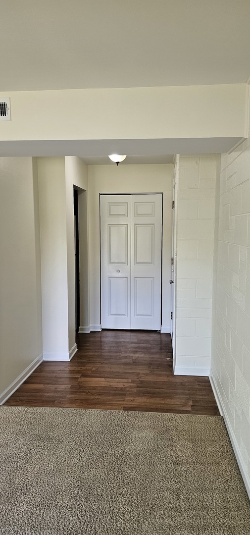 833 Village Quarter Road, Unit A3 West Dundee, IL 60118 - Photo 27 of 27 a view of an empty room with wooden floor and a window