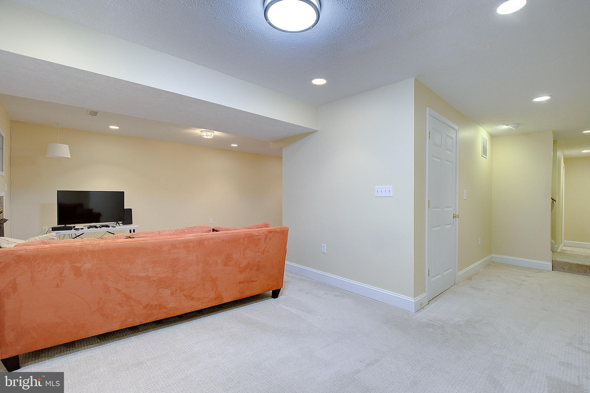 3305 Smithville Drive Dunkirk, MD 20754 - Photo 46 of 109 a living room with furniture and a flat screen tv
