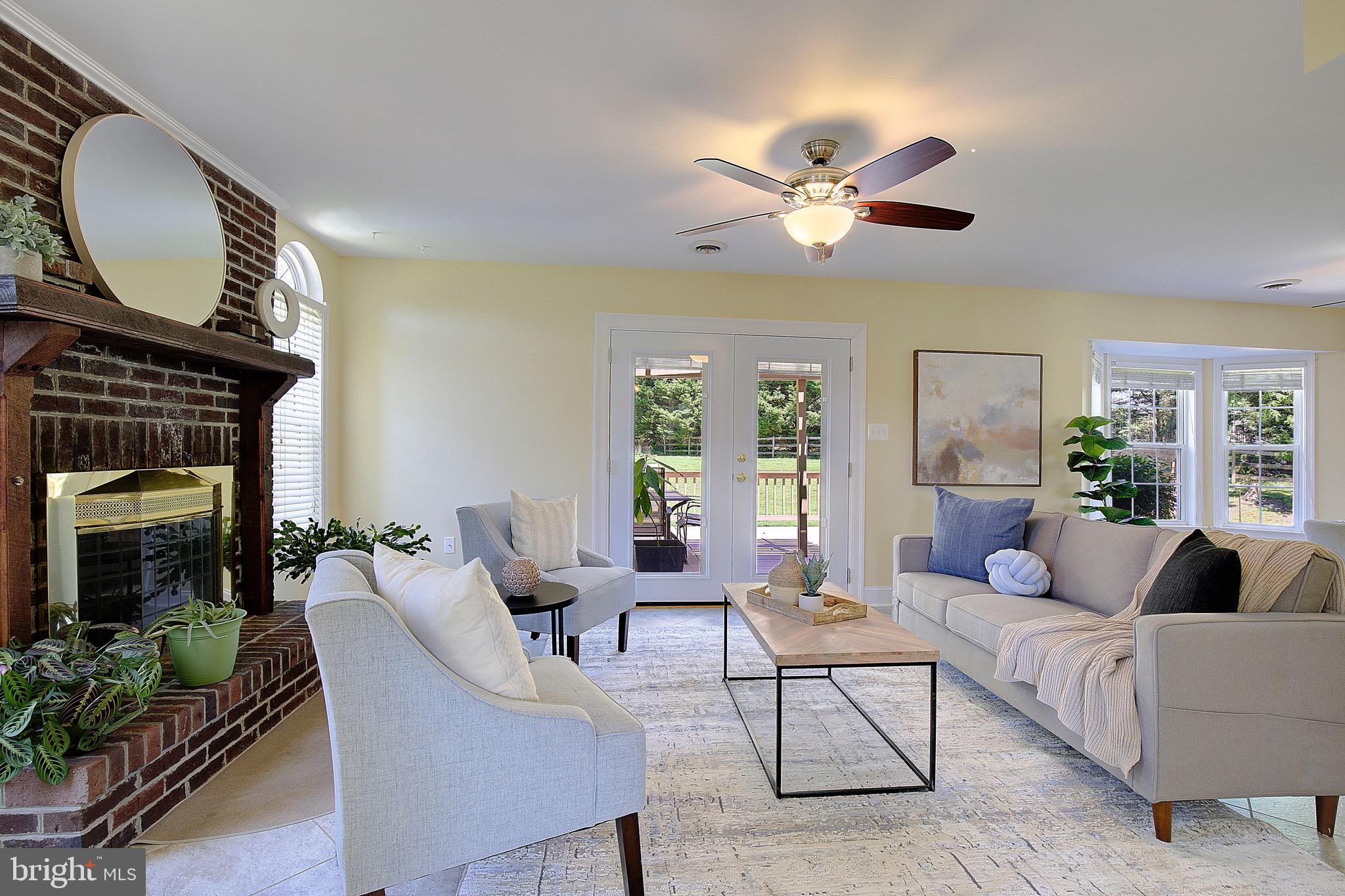 3305 Smithville Drive Dunkirk, MD 20754 - Photo 6 of 109 a living room with furniture a fireplace and a chandelier