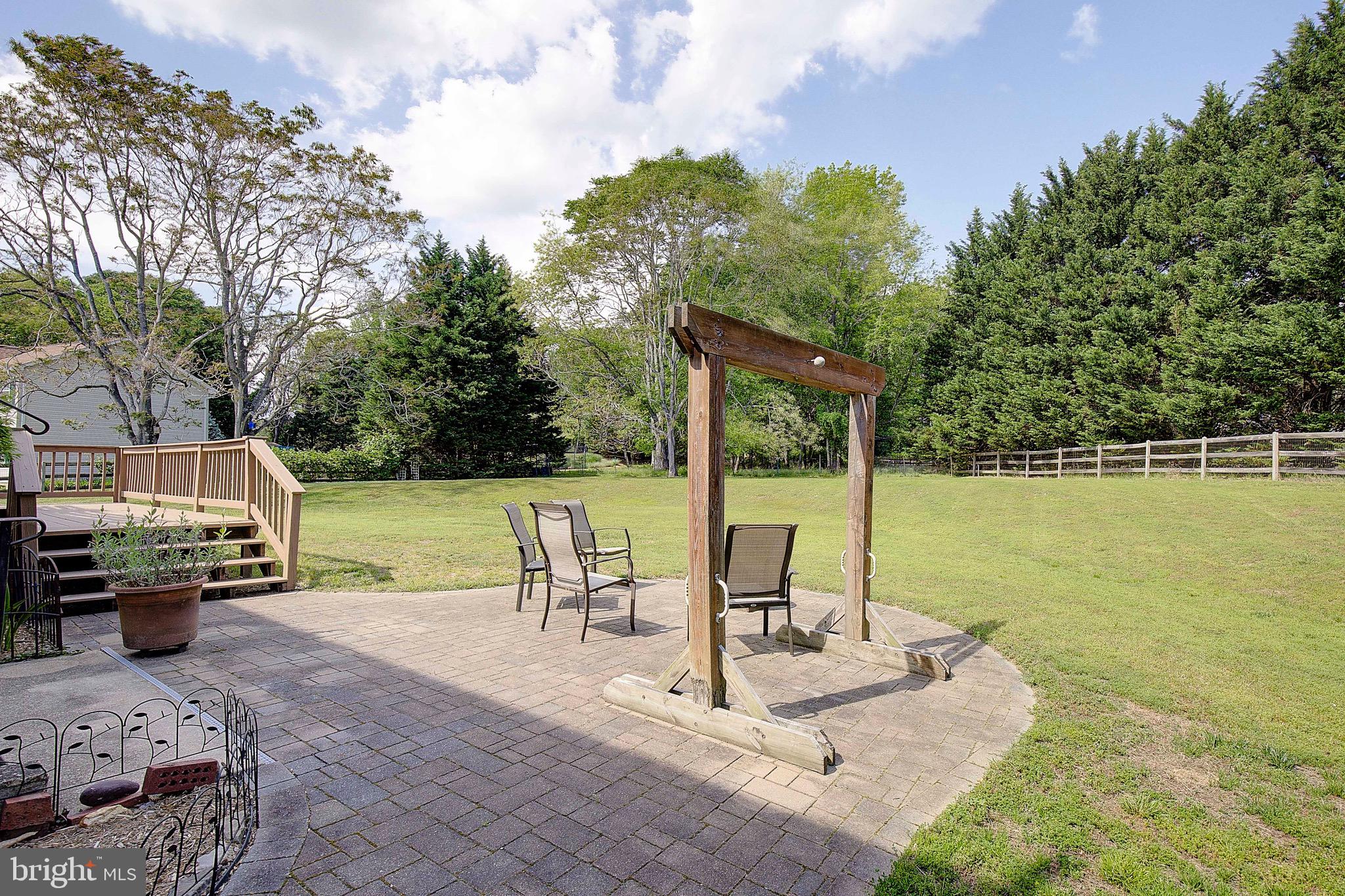 3305 Smithville Drive Dunkirk, MD 20754 - Photo 62 of 109 a view of a patio with a dining table and chairs with wooden floor and fence