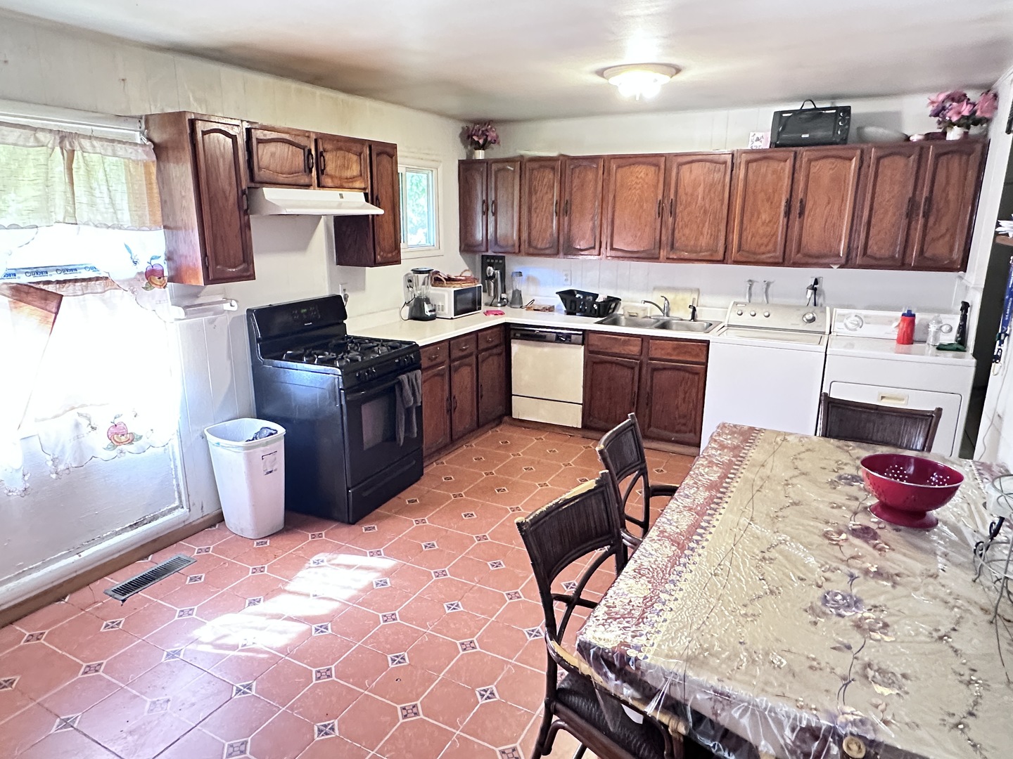 57 Robin Road Carpentersville, IL 60110 - Photo 3 of 11 a kitchen with a sink refrigerator and cabinets