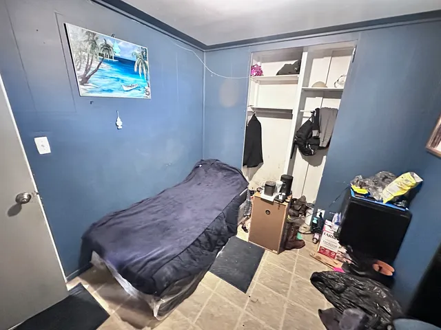 a bedroom with a bed and furniture