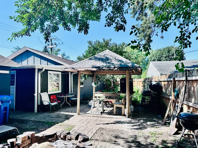 a view of a house with backyard sitting area and porch