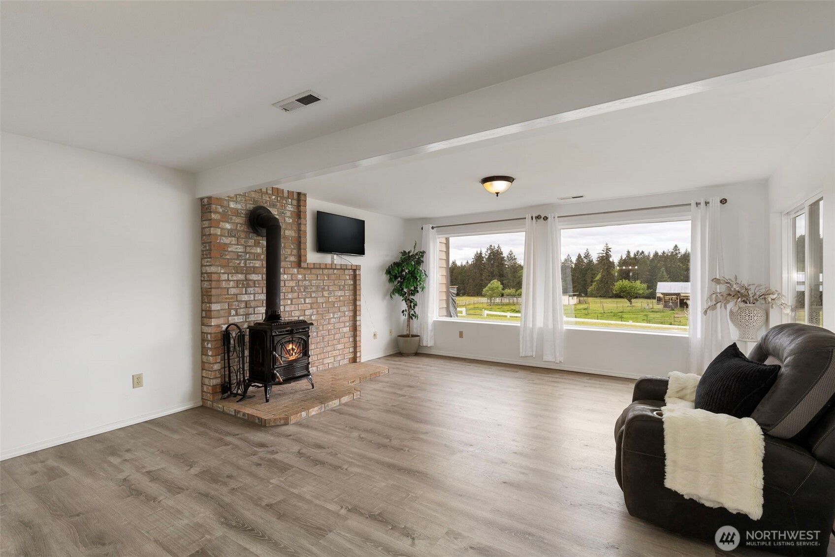 14110 Glenwood Road Southwest Port Orchard, WA 98367 - Photo 21 of 40 a living room with furniture large window and a flat screen tv