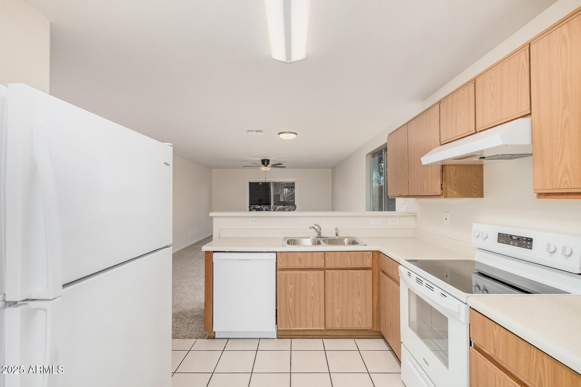 2176 West 20th Avenue Apache Junction, AZ 85120 - Photo 12 of 30 a kitchen with a sink a stove top oven and white cabinets