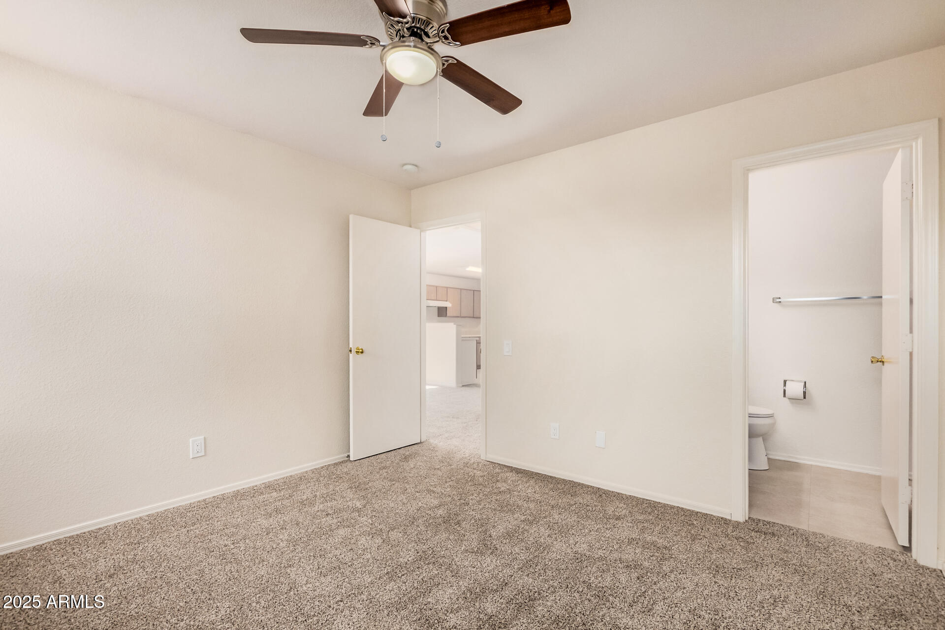 2176 West 20th Avenue Apache Junction, AZ 85120 - Photo 17 of 30 an empty room with closet and a chandelier fan