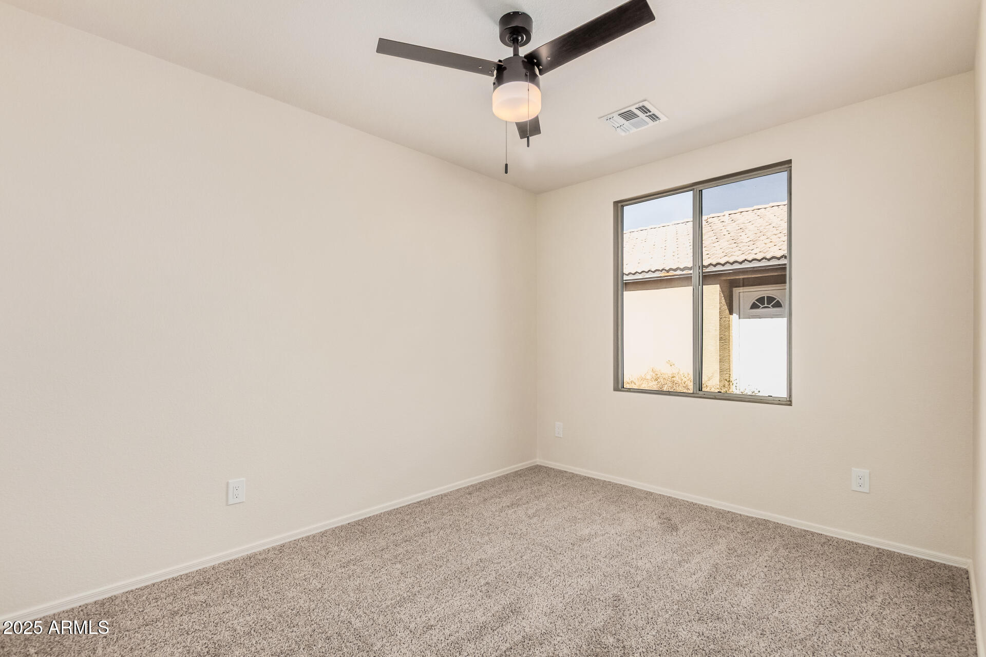 2176 West 20th Avenue Apache Junction, AZ 85120 - Photo 21 of 30 an empty room with windows and fan