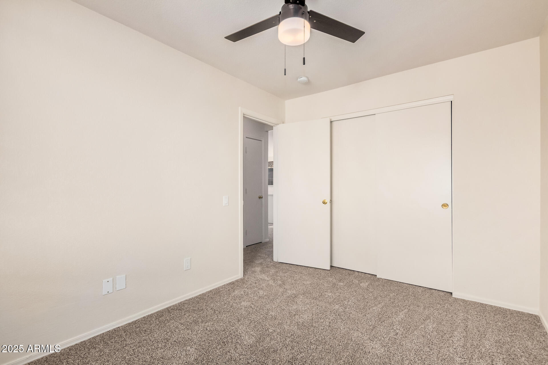 2176 West 20th Avenue Apache Junction, AZ 85120 - Photo 22 of 30 an empty room with a ceiling fan and a window