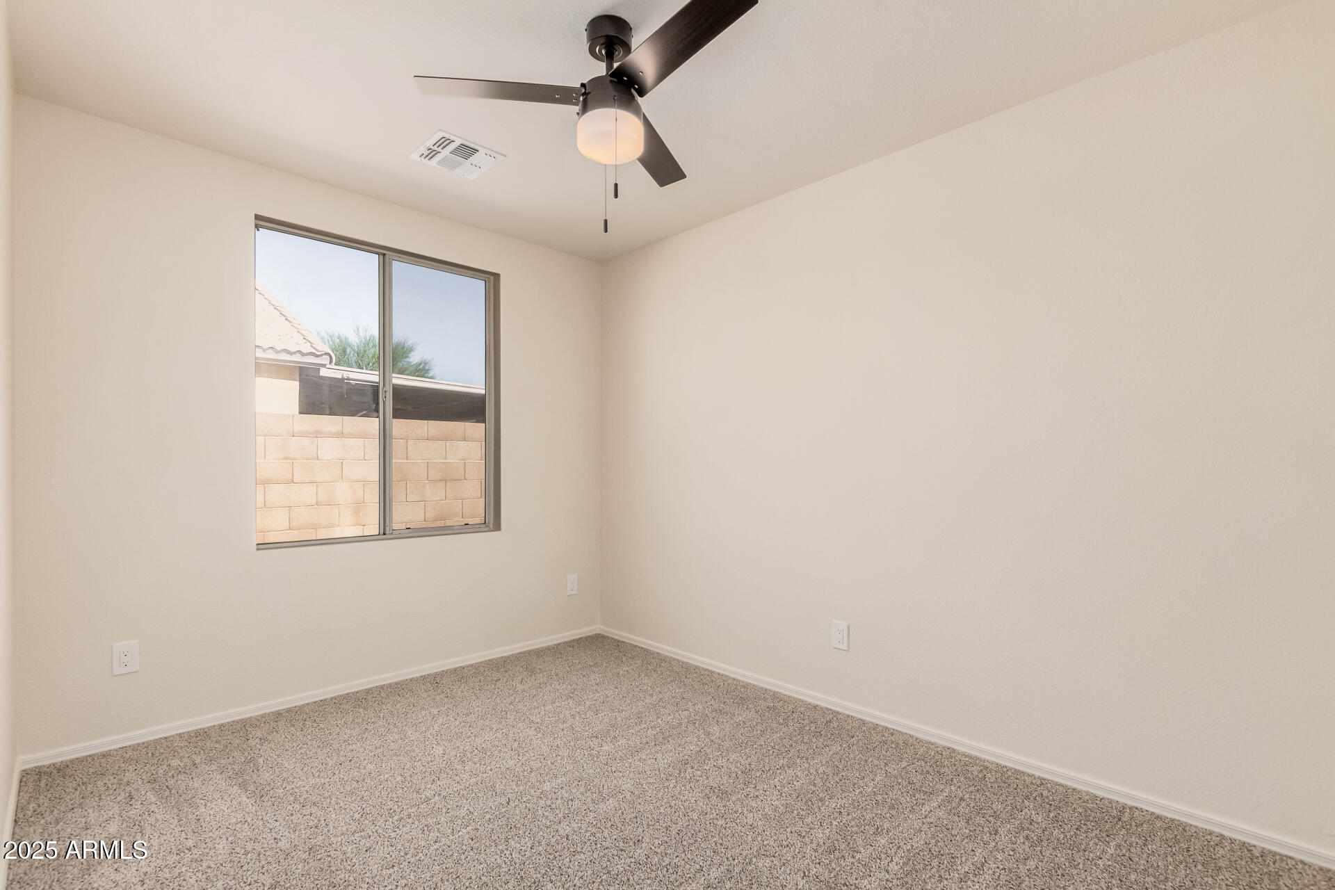 2176 West 20th Avenue Apache Junction, AZ 85120 - Photo 23 of 30 an empty room with a window and a fan