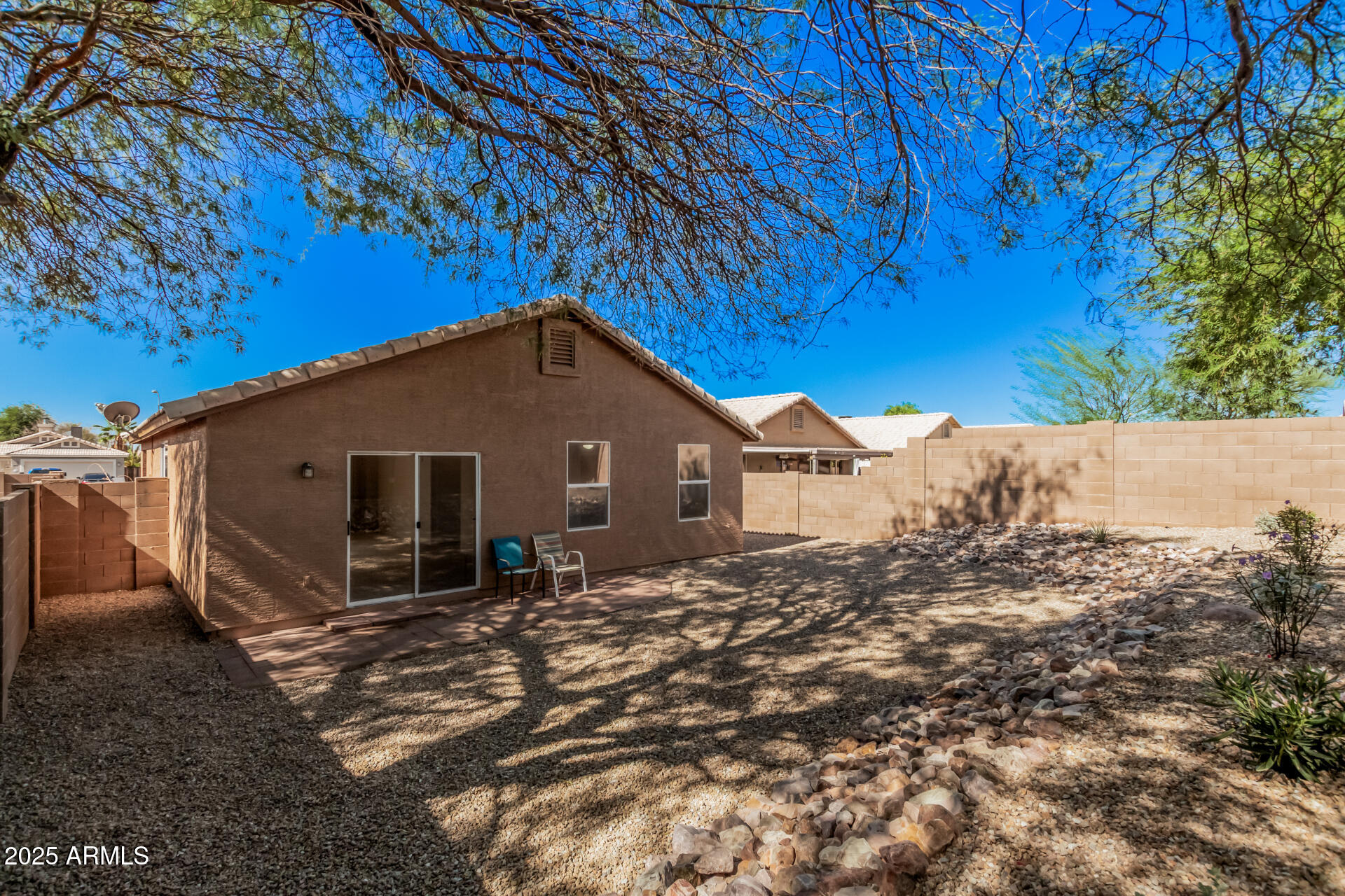 2176 West 20th Avenue Apache Junction, AZ 85120 - Photo 30 of 30 a house with a large tree in front of it