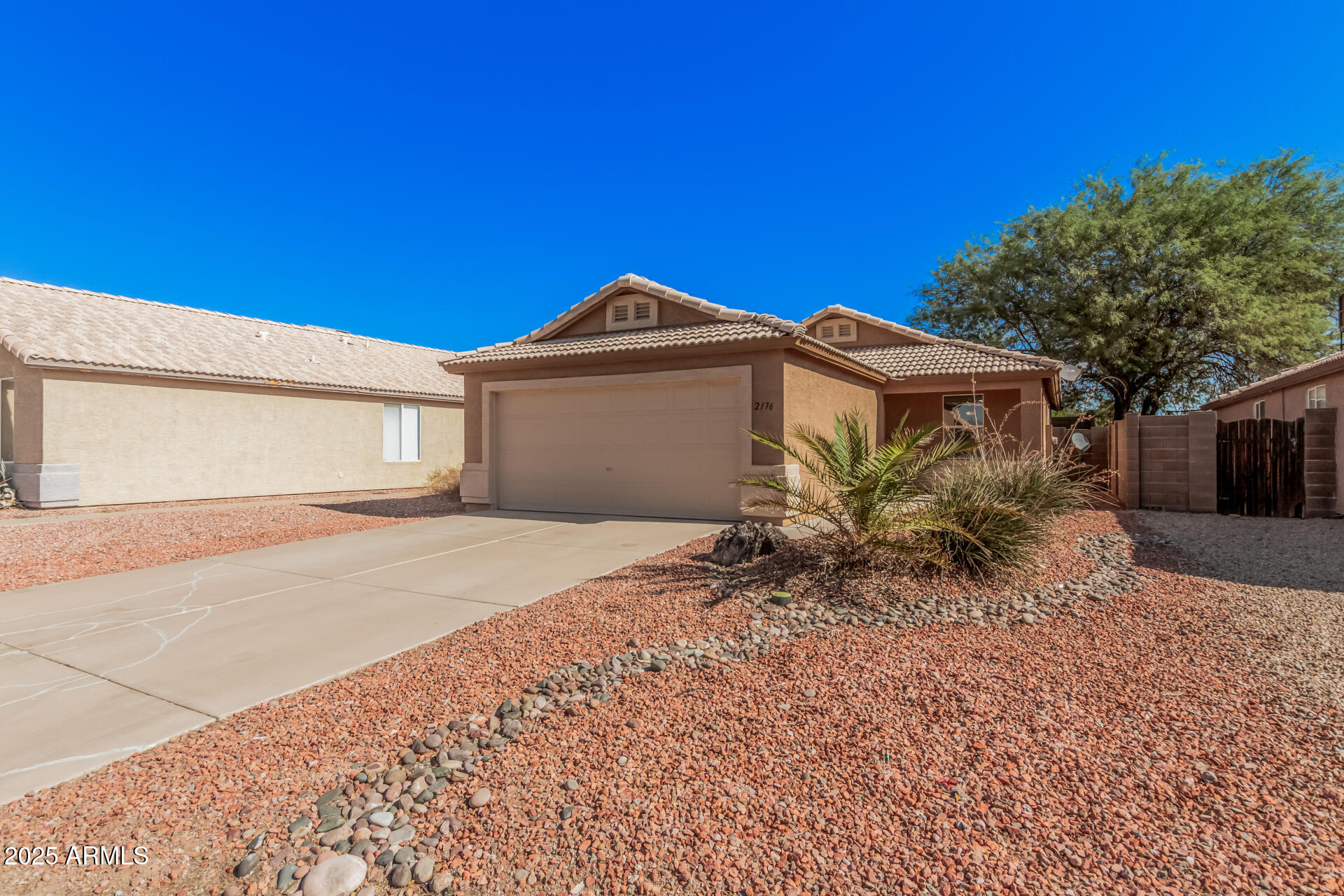 2176 West 20th Avenue Apache Junction, AZ 85120 - Photo 4 of 30 a front view of a house with a yard and garage