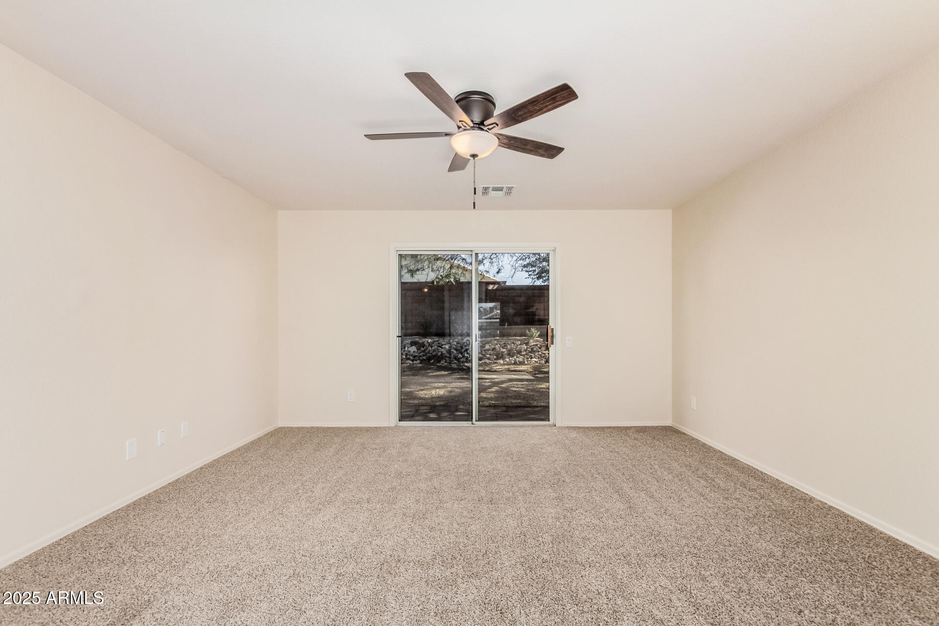 2176 West 20th Avenue Apache Junction, AZ 85120 - Photo 7 of 30 an empty room with chandelier fan and windows