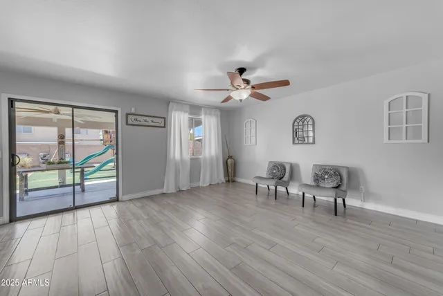 a spacious bedroom with a bed and a chandelier